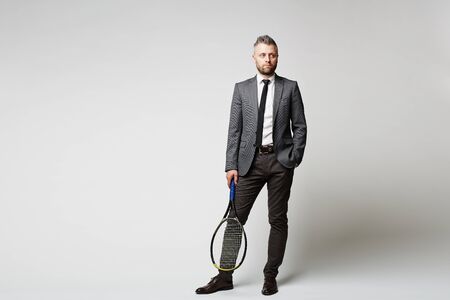 Portrait of businessman holding racketの写真素材