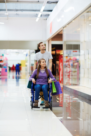 Young couple of shoppers spending time in trade centerの写真素材