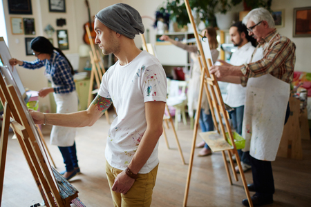 Group of students painting at art lessonsの写真素材