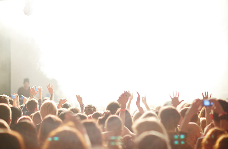 People in front of bright stage lightsの写真素材