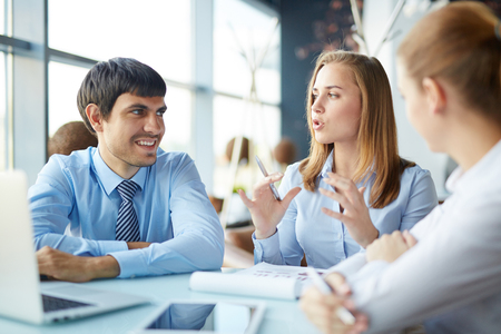 Young employee explaining her colleagues new projectの写真素材