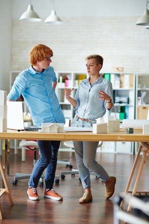 Two designers discussing new tendencies in modern architectureの写真素材