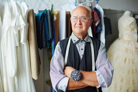 Confident tailor looking at camera in workshopの写真素材