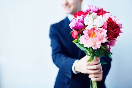 Close-up of a splendid bouquet in hands of a manの写真素材