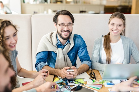 Happy young specialists discussing plansの写真素材