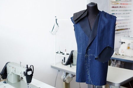 Unfinished jacket and trousers on mannequin in tailor workshopの写真素材