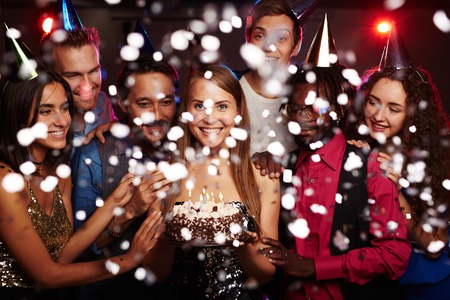 Happy young friends having birthday party