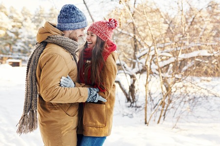 Happy young guy and girl enjoying their date in park