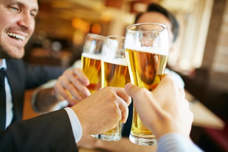 Businessmen drinking beer after successful dealの写真素材