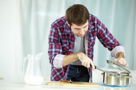 Portrait of man preparing food at kitchenの写真素材