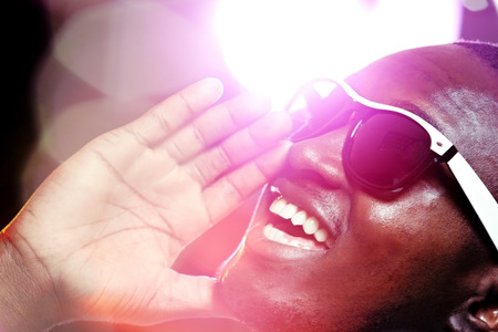 Happy man screaming in neon lightの写真素材