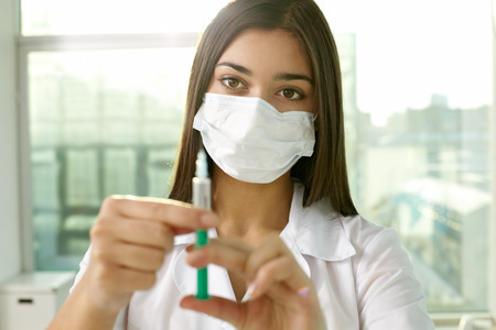 Portrait of young nurse filling the syringeの写真素材