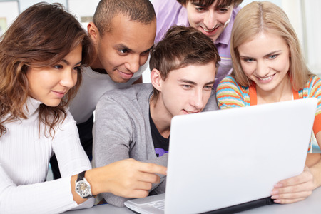 Five young people are absorbed in computerの写真素材