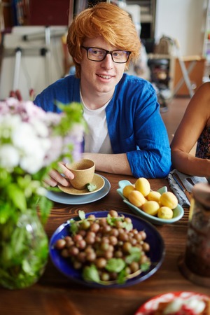 Guy sitting by Thanksgiving table during dinnerの写真素材