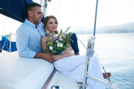 Just married couple traveling by sea on yachtの写真素材