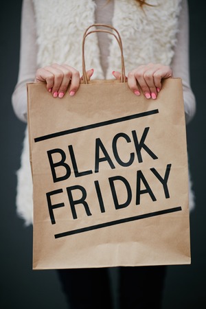 Black Friday purchase in paperbag held by consumerの写真素材