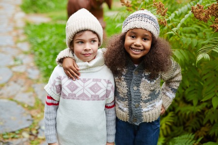 Happy yothful girl embracing her school friendの写真素材