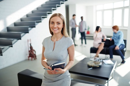 Qualified specialist looking at camera in working environmentの写真素材