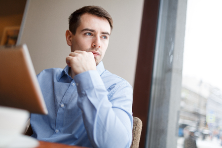 Young author thinking of ideas in cafeの写真素材