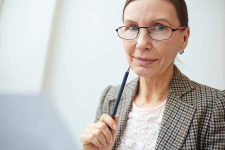 Mature entrepreneur or accountant looking at cameraの写真素材