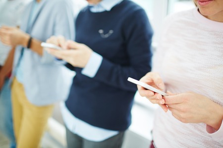 Group of modern teens with smartphones texting messages