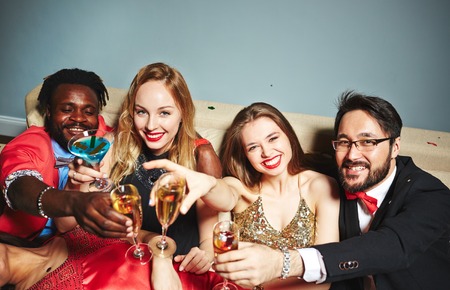 Toasting young people looking at camera