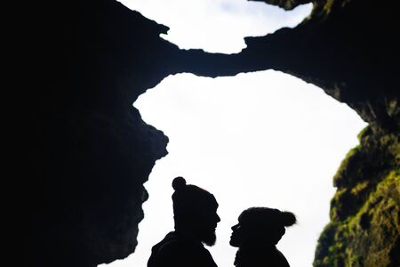 Outlines of sweethearts looking at one another in natural environmentの写真素材