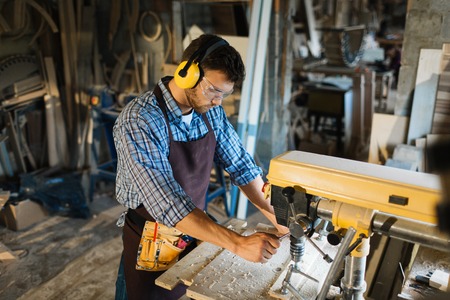 Owner of manufacturing business working on drill machineの写真素材