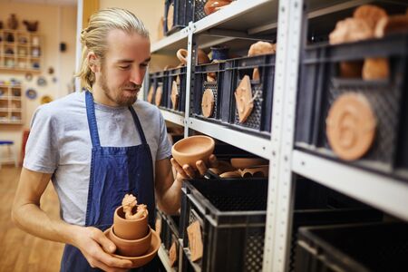 Master of pottery working in his atelier of earthenwareの写真素材