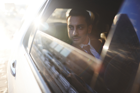 Luxurious car with rich businessman insideの写真素材