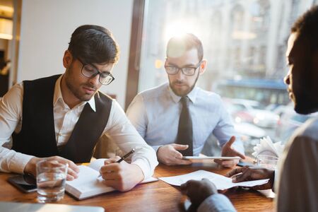Businessmen working in cafe
