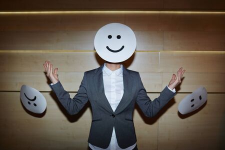 Businesswoman hiding her face under maskの写真素材