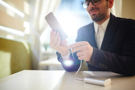 Young Businessman Charging Smartphoneの写真素材