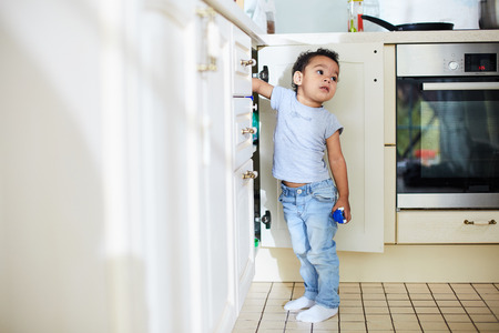 Playful toddler boy in kitchenの写真素材