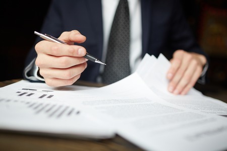 Businessman Reviewing Financial Papersの写真素材