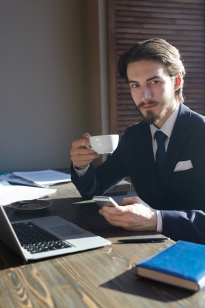 Handsome Elegant Businessman Working in Coffee Break