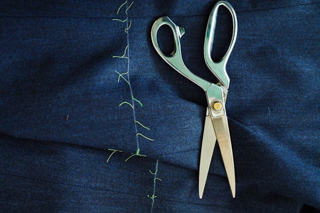 Scissors and piece of dark blue fabricの写真素材