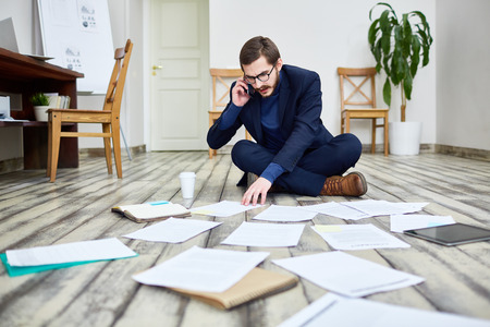 Businessman Working on Floor in Office