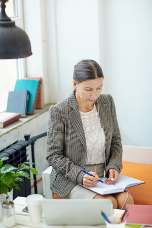 Senior Entrepreneur Wrapped up in Workの写真素材