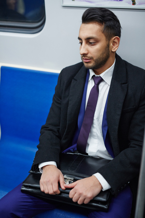 Tired Middle-Eastern Businessman on Subway trainの写真素材