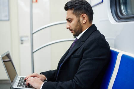 Businessman with Laptop in Subwayの写真素材
