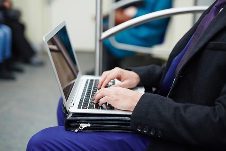 Businessman Working with Laptop in Subwayの写真素材