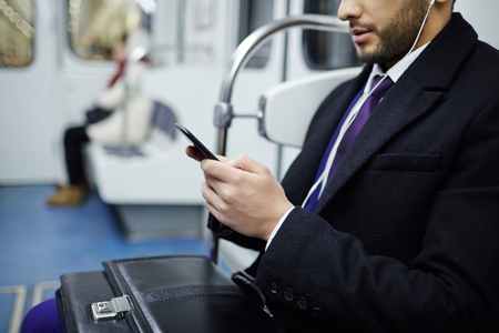 Businessman Listening to Music in Subwayの写真素材