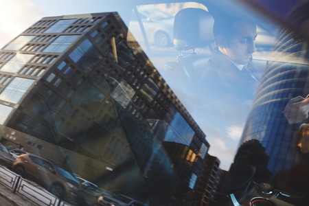 City Reflection in Car Window