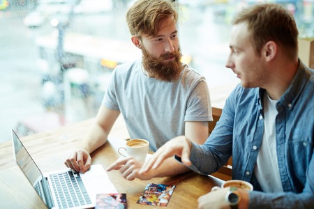 Bearded Friends Chatting in Coffeehouse