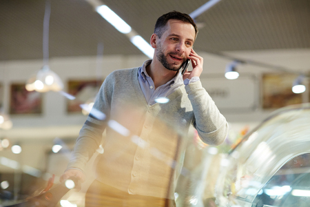 Man Calling Wife from Grocery Storeの写真素材