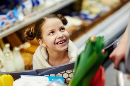 Little Daughter Shopping in Supermarketの写真素材