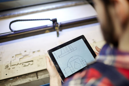 Worker  Operating Laser Cutting Machineの写真素材