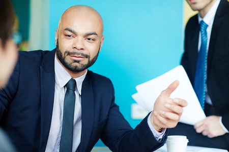 Confident Bald Businessman Making Dealの写真素材