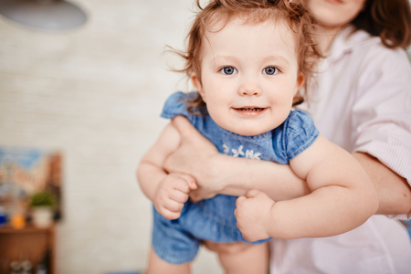 Angelic Little Girl on Mothers Armsの写真素材